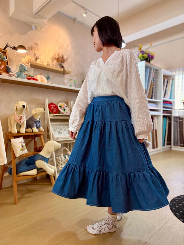 A student wearing a tiered denim skirt she sewed